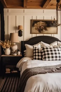 a black and white checkered bed with two lamps on each side, in a rustic style bedroom