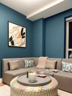 a living room with blue walls and furniture