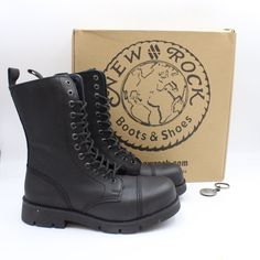 a pair of black boots sitting next to a box