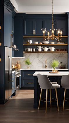 a kitchen with dark blue cabinets and white counter tops, gold chandelier over the island