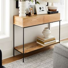 a wooden table topped with books and vases