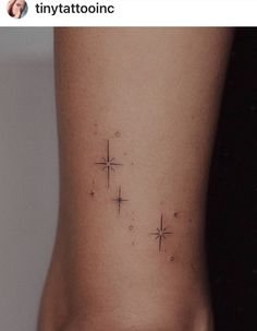 a small star tattoo on the side of a woman's right leg, which has three stars in it