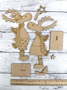 wooden cutout of two deers and a ruler