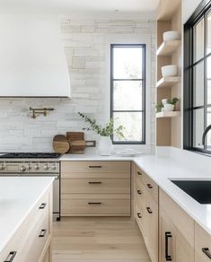 a kitchen with white counter tops and wooden cabinets