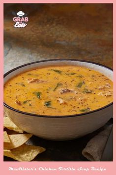 a bowl of soup with tortilla chips on the side