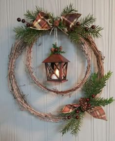 a wreath with a lit candle hanging from it