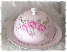 a cake decorated with pink roses on a plate