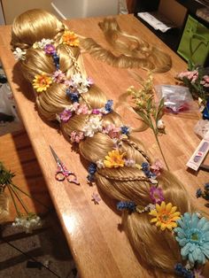 a wooden table topped with long blonde hair and flowers