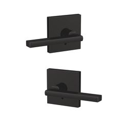 two black square wall mounted toilet paper dispenser holders with one open and the other closed