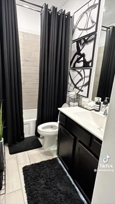 a bathroom with black and white decor in it