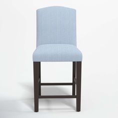 a blue and white striped bar stool against a white background with the seat upholstered