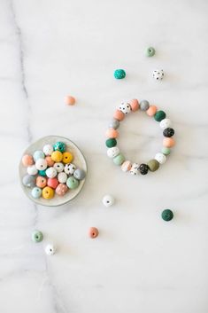 an assortment of beads on a marble surface