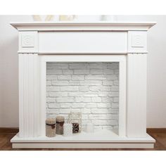 a white brick fireplace with three candles on the mantle and one candle holder next to it