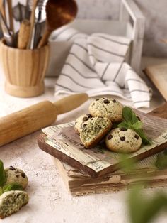 some cookies are sitting on top of an old book and next to utensils