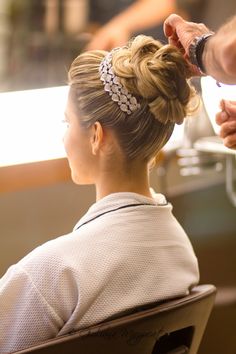 a woman is getting her hair done at the salon