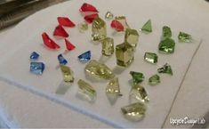 many different colored diamonds on a white surface