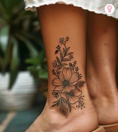 a woman's foot with a flower tattoo on her left ankle and the bottom part of her leg