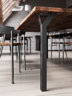 a wooden table with metal legs and chairs