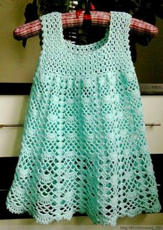 a green dress hanging on a clothes rack