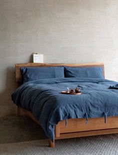 a bed with blue sheets and pillows in a room