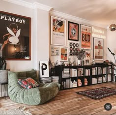 a living room filled with lots of furniture and pictures on the wall next to a bookshelf