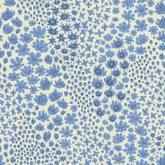 a blue and white flower pattern on a light yellow wallpaper with small dots in the center