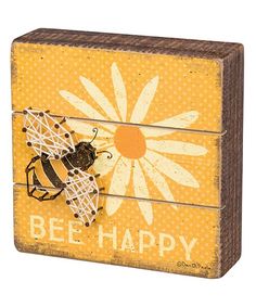 a wooden box with a bee on it and the words bee happy written in white