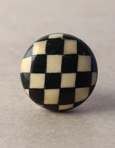 a black and white checkered ball sitting on top of a table