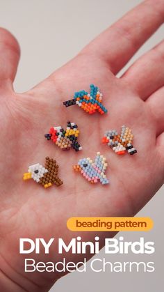 the beading pattern for mini birds is on someone's hand