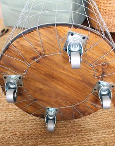 a wooden table topped with metal brackets and a wire basket on top of the table