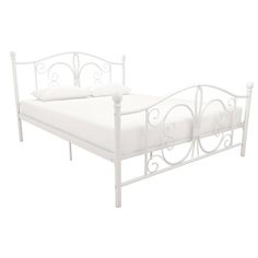 a white metal bed frame with two pillows