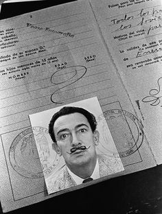 an image of a man with a mustache on top of a passport and some papers