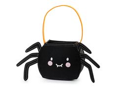 a small black bag with a spider on it's face and two eyes, hanging from an orange handle