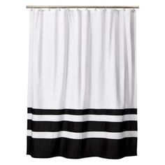 a shower curtain with black and white stripes on the bottom, in front of a white background