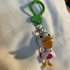 a keychain with a cartoon character on it's front and back ends