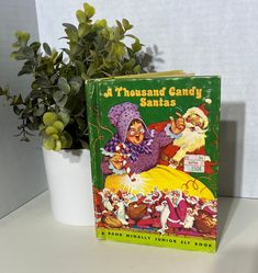 a book sitting on top of a table next to a potted plant