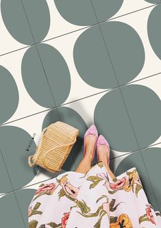 a woman laying on the floor with her legs crossed and wearing pink high heeled shoes