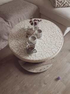 a coffee table with two cups on it