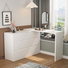 a white dresser sitting next to a window with a mirror on it's side