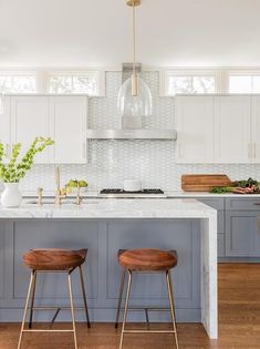 two stools are in front of the kitchen island