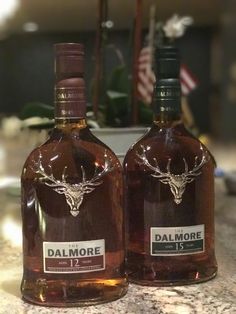 two bottles of dalmore are sitting on the counter