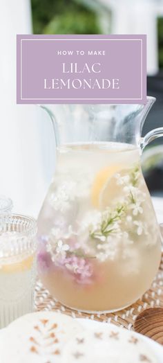 a pitcher filled with lemonade sitting on top of a table next to plates and cups