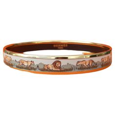 Beautiful Authentic Hermès Bracelet Print: Lions and lionesses in Savannah Theme: Africa, wild animals, jungle, savannah Made in Austria + B (1998) Vintage Bracelet Made of printed enamel and yellow gold plated hardware Colorways: beige, shades of green "HERMÈS PARIS" in golden letters inside Hallmark Size: 65 - PM Measurements: 6,5 cm Diameter (2,56 inches) / 0,95 cm Width (0,35 inch) Condition: Very Good. Enamel in excellent condition: no chips, no scratch. Micro scratches on hardware. No Hermès packaging. Will come gift wrapped This bracelet is garanteed authentic and will be shipped immediately Thank you for watching my items ! Beige Shades, Animals Jungle, Lion And Lioness, Hermes Bracelet, Vintage Hermes, Hermes Paris, Vintage Bracelet, Enamel Bracelet, Dream Jewelry