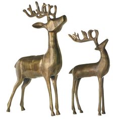 two metal deer statues standing next to each other