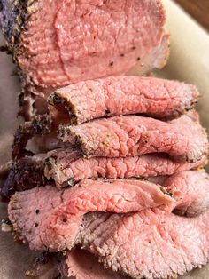 sliced meat sitting on top of a cutting board