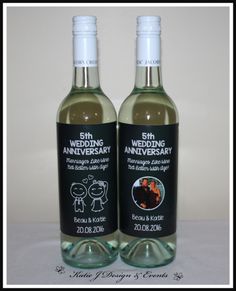 two bottles of wedding anniversary wine on a white tablecloth with the label in black