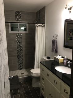 a bathroom with a toilet, sink and shower