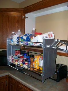 an open refrigerator in a kitchen next to a counter