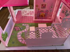 a doll house with pink furniture and accessories