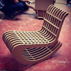 a chair made out of cardboard sitting on the floor